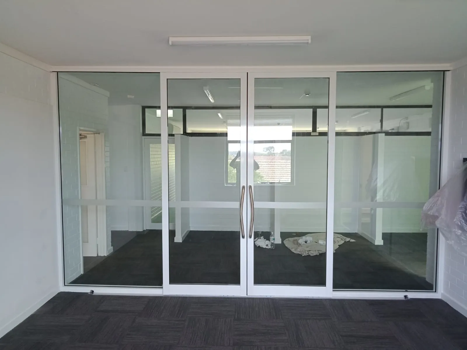 An aluminium framed glass office partition with double doors