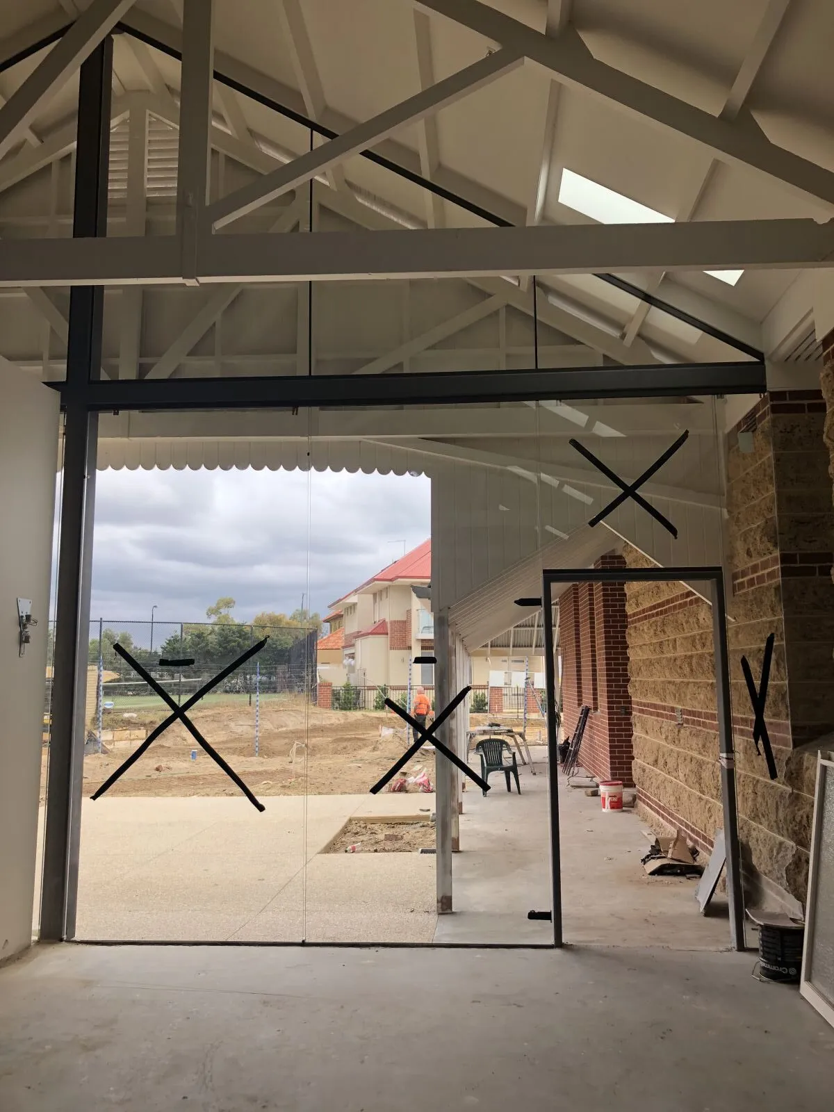 Glass doors with safety crosses under a timber roof truss