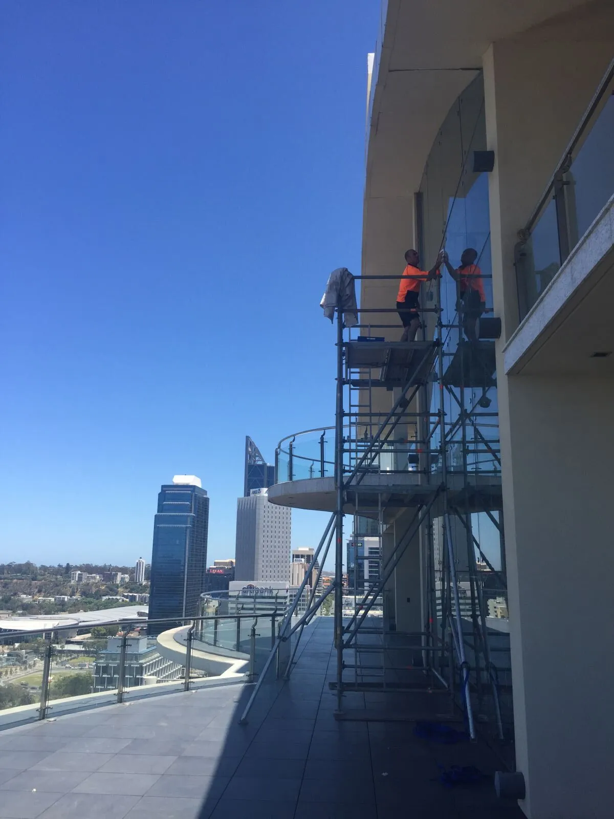 Scaffold tower against a high-rise balcony