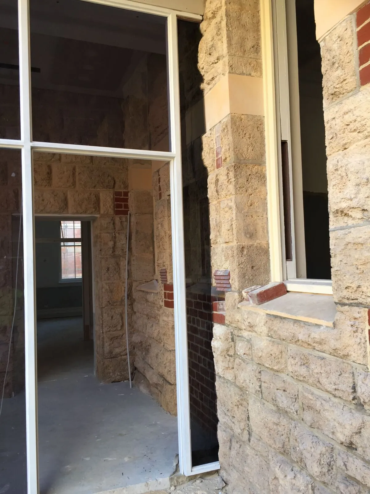 Glass panels set into a sandstone wall
