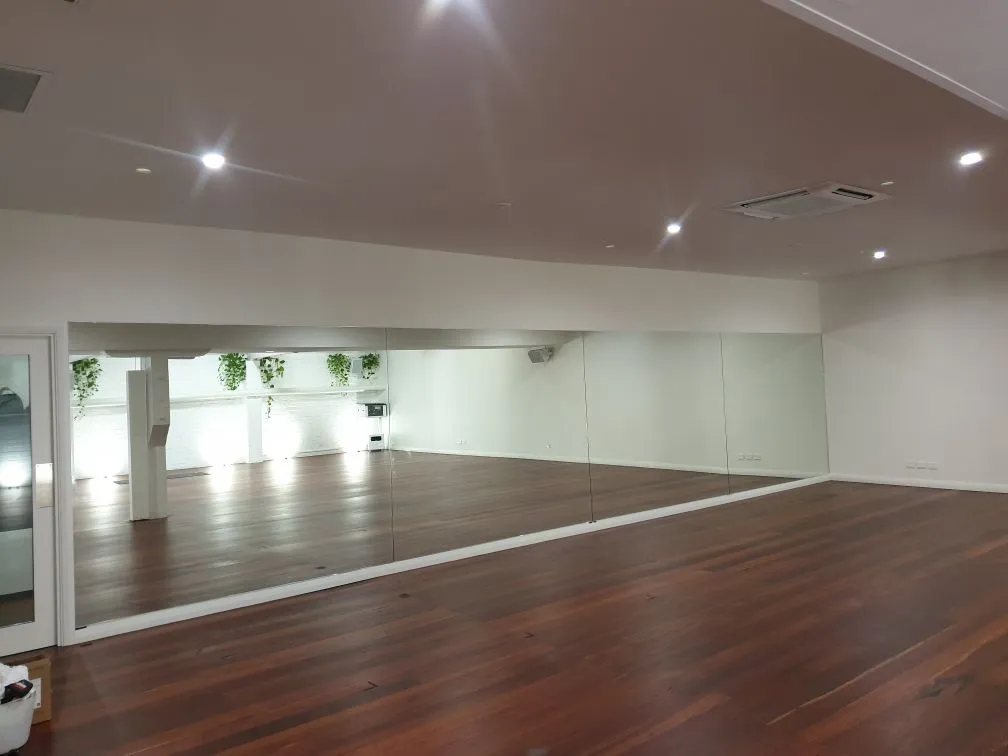 Mirrored studio wall with timber floors