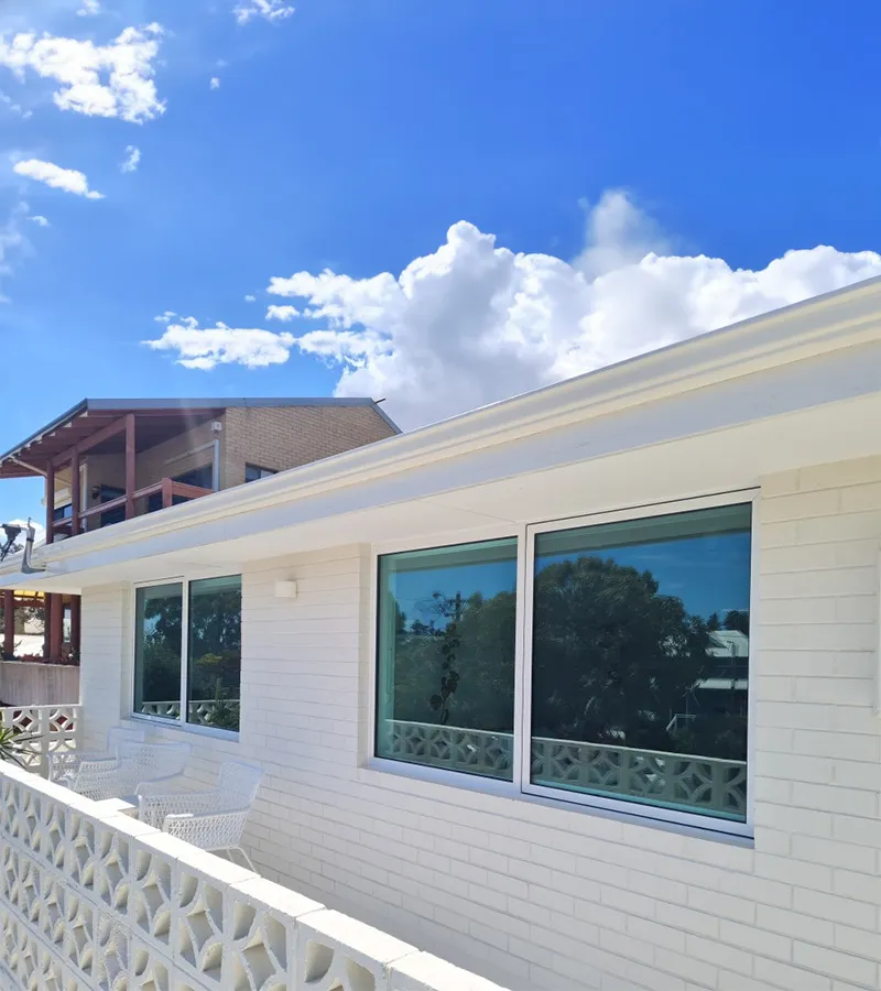 New aluminium framed windows on a white weatherboard home